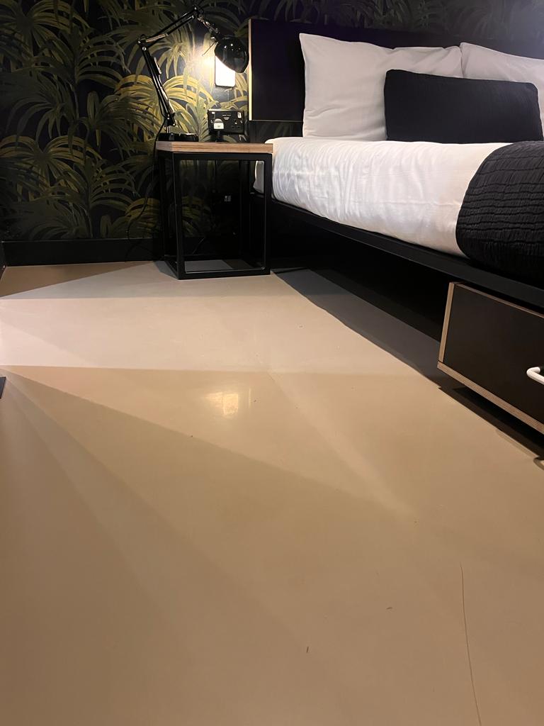 bedroom concrete polished flooring with a cream finish